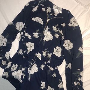 A long sleeve, zip-up, floral shirt